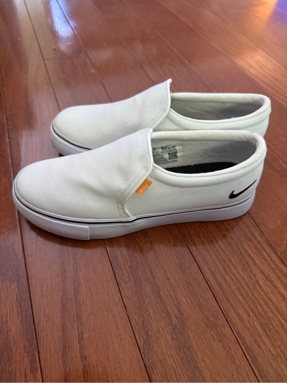 Nike White Canvas Slip-On Sneakers with Black Swoosh